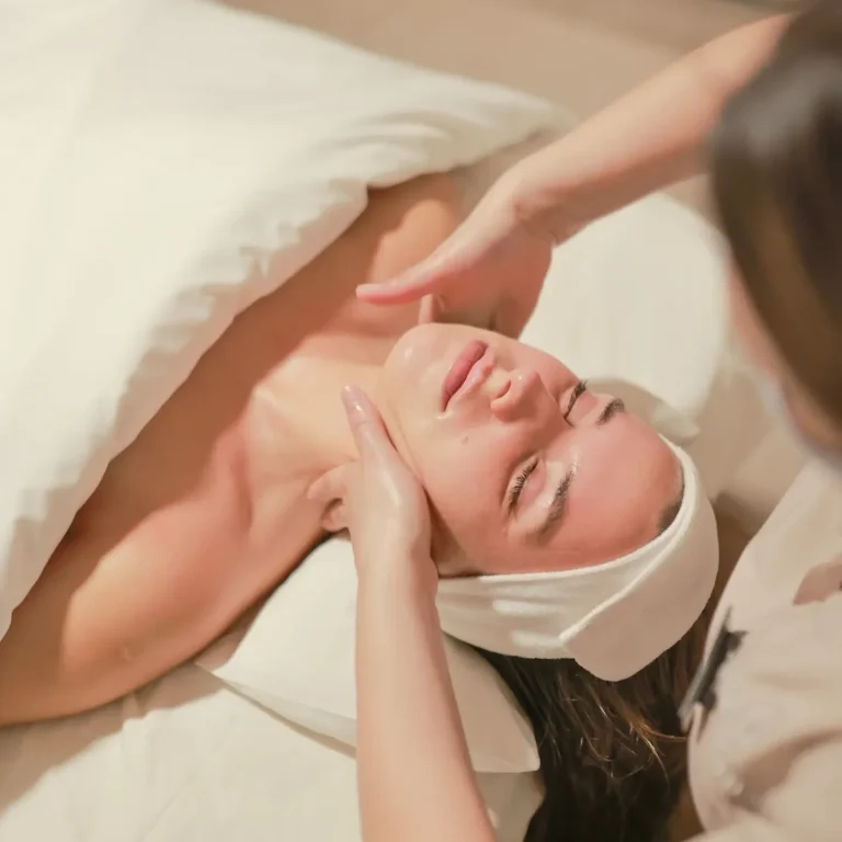 Woman receiving a facial treatment in the comfort of her home in Marbella