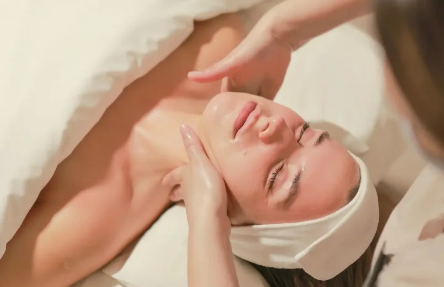 Woman receiving a facial treatment in a relaxing environment.
