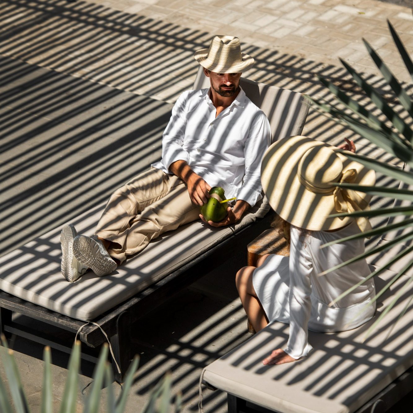 Poolside scene with a masseuse giving a massage outdoors in an exclusive villa in Marbella