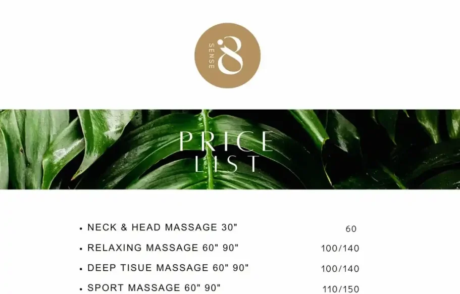 Young couple sitting on the sofa, laughing and looking at the phone, choosing their home massage in Marbella.