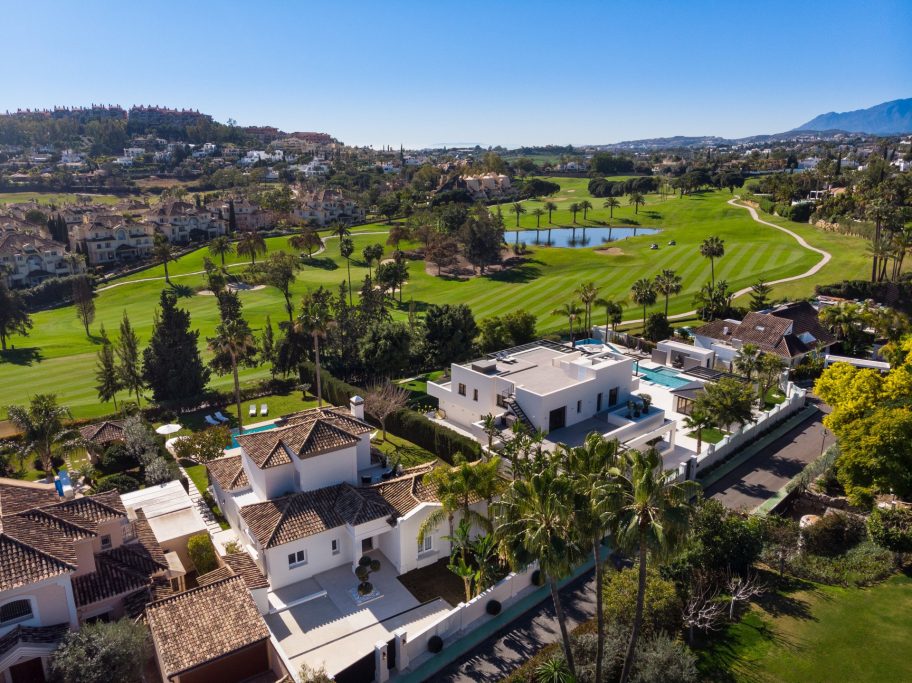 Aerial view of a luxurious villa surrounded by golf courses and lush vegetation.Enjoy the experience of a massage at home in Nueva Andalucia