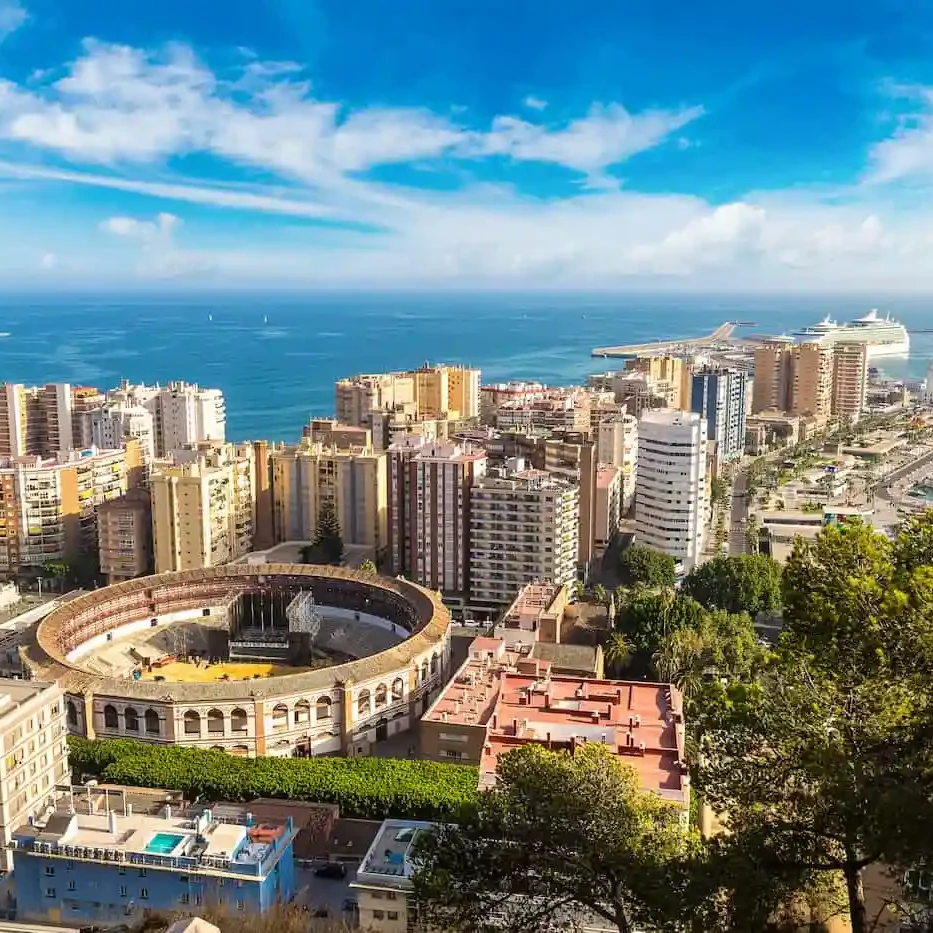 Panoramic view of the city with an ancient Roman theatre and the sea in the background.