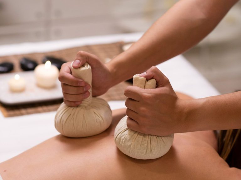 Person receiving a Thai massage in Marbella in a relaxing candlelit setting