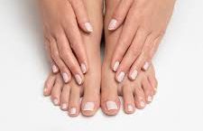 Hands and feet with manicured nails, on white background.