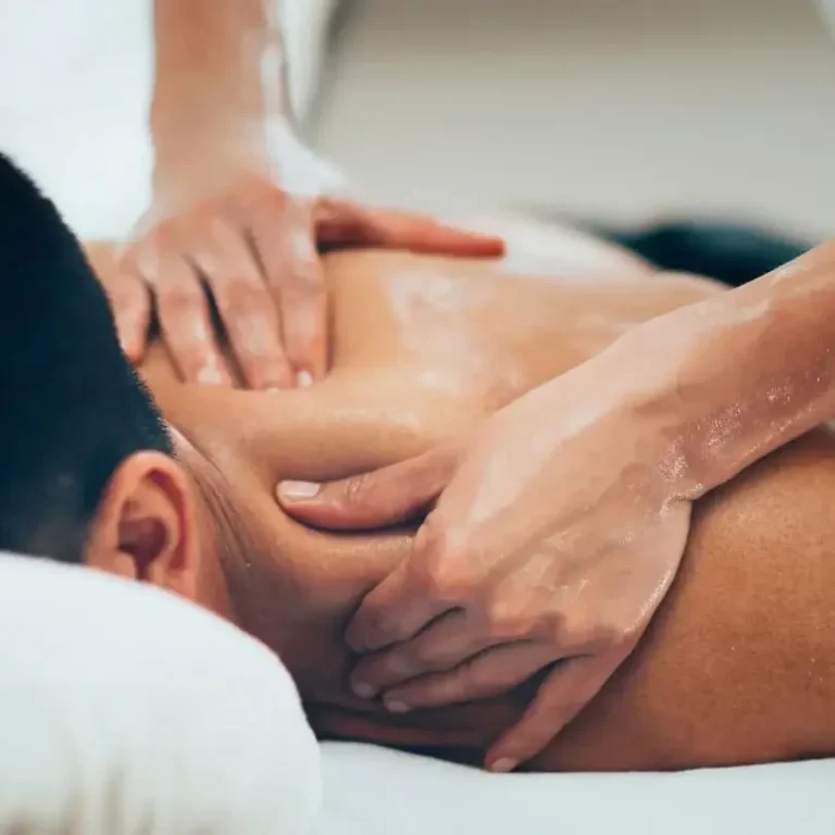 
Massage on a person's back, with hands applying pressure and relaxation