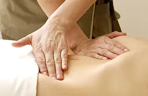 Massage technique with hands on the back of a person in relaxation.