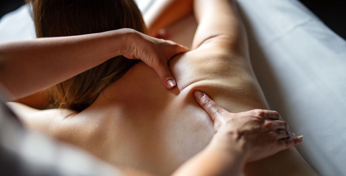 Home Massage in Malaga Person receiving a back massage in a relaxing environment at home