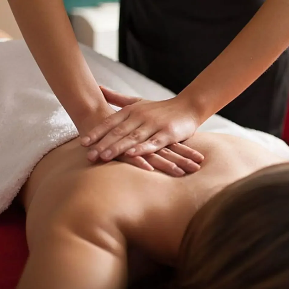 Relaxing massage on the back of a person with hands on the skin.
