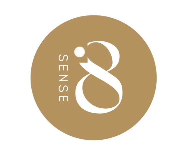 ‘SENSE8’ logo in a golden circle with white text. Schedule your home massage experience with us in Marbella, Spain.