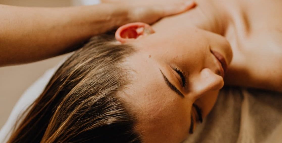 Home Massage Marbella Woman receiving a relaxing massage at home in a peaceful environment.