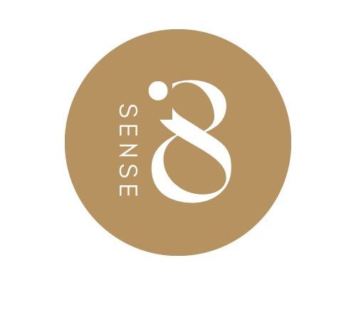 ‘SENSE8’ logo in a golden circle with white text. Schedule your home massage experience with us in Marbella, Spain.