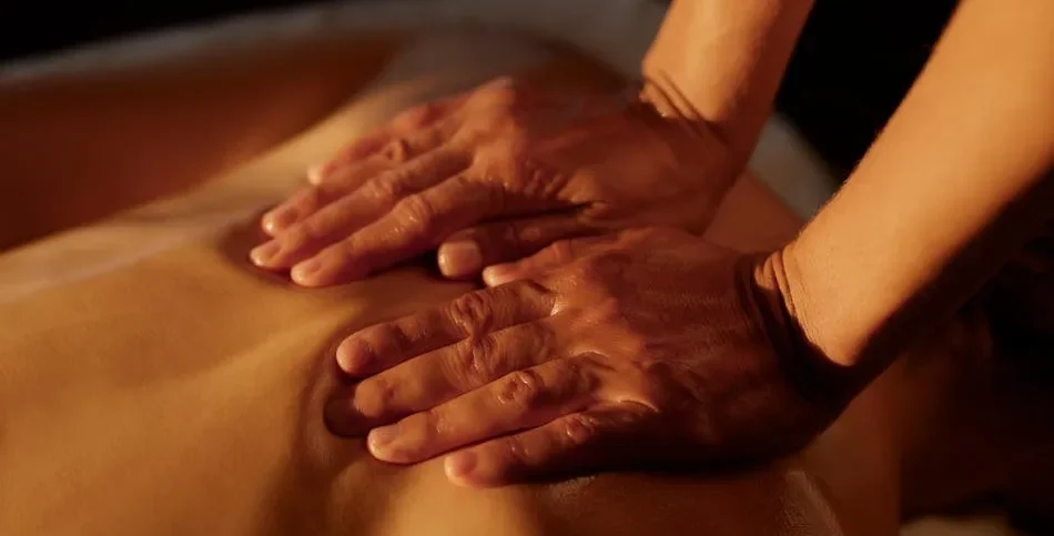 Woman receiving a relaxing massage at home in a peaceful environment.