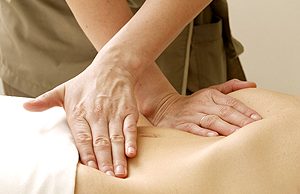 Massage technique with hands on the back of a person in relaxation.